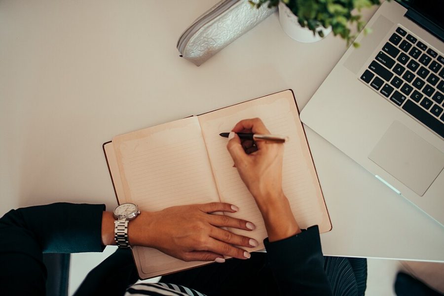 Planning notes beside a laptop